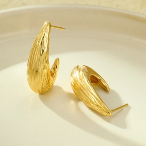 Polished gold C-shaped stainless steel drop earrings with textured brushed finish on tray