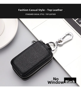 Close-up of black lychee grain genuine leather key pouch with dual silver zippers