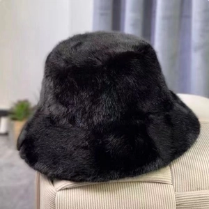 Close-up of a soft black faux fur bucket hat showcasing plush and fluffy texture