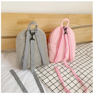 Detail view of plush kids backpack adjustable straps in pink and grey color options