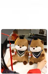 Detail of cute graduation otter plush toy wearing black doctoral cap and academic stole