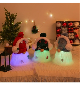Three glowing Christmas gnomes with knit hats and snowflake patterns in a cozy setting
