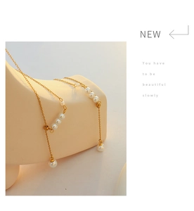 Close-up of gold chain pearl necklace on mannequin featuring elegant minimalist design