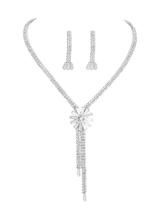 Close-up of silver flower necklace and long tassel earrings set with zircon stones