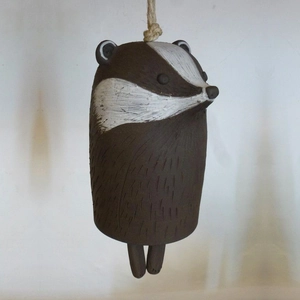 Handmade resin badger wind chime with rustic fur texture and hanging rope for garden decor
