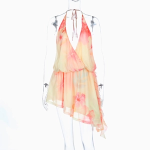 Detail of floral chiffon halter dress with pink hibiscus print and backless cut