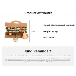 Detail of bohemian multilayer sandalwood bracelet with tree of life charm and orange tassel