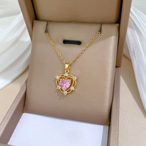 Close-up of heart-shaped pink crystal pendant necklace in a luxury jewelry box
