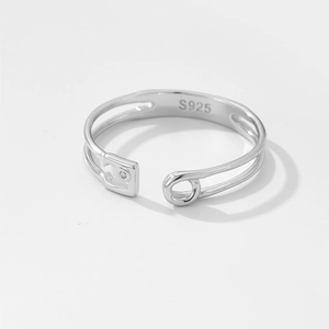 Detailed macro view of S925 sterling silver safety pin ring with small diamond inlay