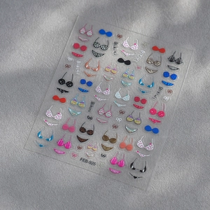 Detailed view of summer 3D embossed bikini and bow nail art stickers with vibrant patterns
