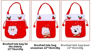 Detailed view of three 22x18cm Christmas gift bags with Santa, snowman and bear designs