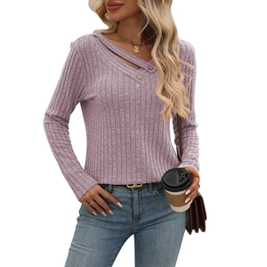 Detailed view of lavender knit top with ribbed texture and decorative buttons on V-neckline
