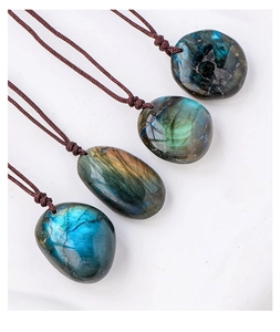 Detailed view of four natural labradorite crystal pendants with colorful blue labradorescence