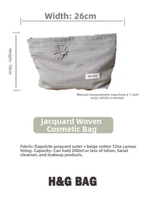 Detail of blue checkered makeup bag with jacquard fabric texture and a flower charm
