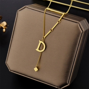 Titanium steel 18K gold necklace with D letter pendant and geometric charms on box