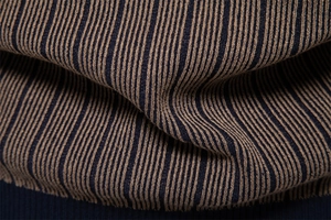 Detailed macro view of the soft rib-knit navy and khaki striped fabric on a men sweater