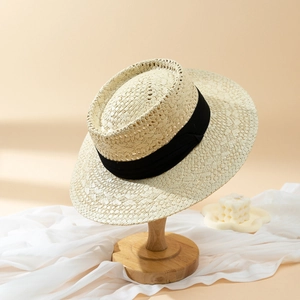 Elegant French vintage boater straw hat with wide black ribbon for sun protection