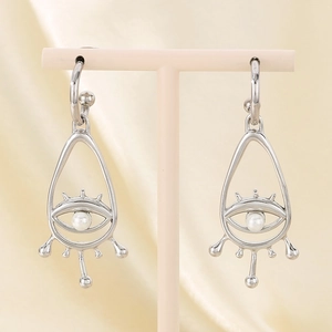 Bohemian Evil Eye drop earrings in silver stainless steel with white pearls on a display