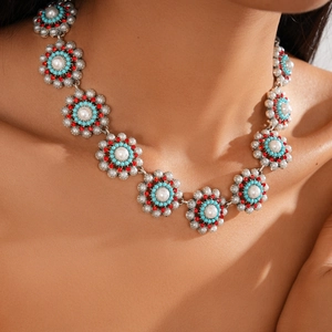 Detailed close-up of bohemian floral necklace with pearls, turquoise, and red crystals