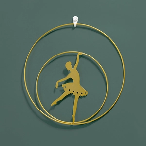 Modern gold iron wall art featuring a ballerina silhouette in concentric metal rings
