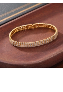 Detail of gold-plated triple-row tennis bracelet with shimmering white zircons