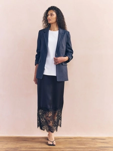 Lace trim black satin midi skirt paired with striped blazer and white t-shirt