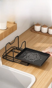 Kitchen rack detail with a removable black drain tray for easy cleaning and maintenance