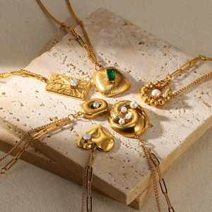 18K gold stainless steel necklaces with pearls and heart pendants on stone base