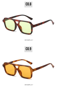 Detail view of square double-bridge sunglasses in tortoiseshell and vibrant orange