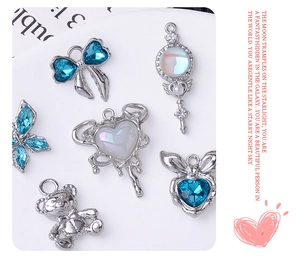 Detailed flat lay of blue rhinestone silver charms including hearts and bows