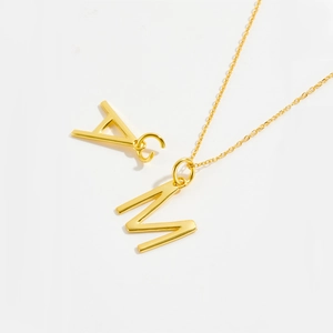 Polished S925 sterling silver gold-plated necklace featuring capital letter M and A charms