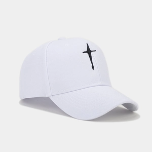 Close-up of white cotton baseball cap showing detailed black embroidery and twill texture