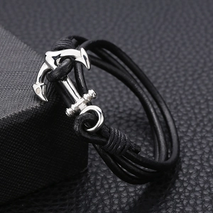 Black multilayer braided leather bracelet with silver anchor charm in nautical style