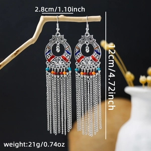 Detail of bohemian long tassel earrings on wood, showing 12cm length and size specs
