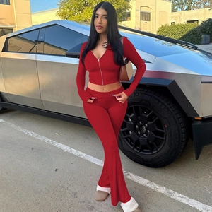 Detail view of red slim fit two-piece set featuring zip hoodie and flared trousers