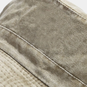 Detailed close-up of washed canvas sun hat featuring vintage stone-washed texture and stitching