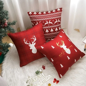 Christmas pillow covers with reindeer and snowflake patterns on a cozy white rug