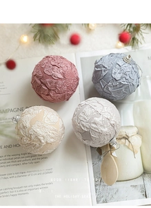 Detailed view of textured fabric Christmas ornaments with silver caps and festive scenery