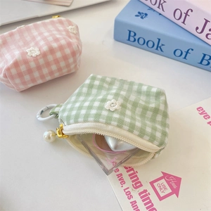 Close-up of mesh plaid coin purse with daisy embroidery and pearl zipper pendant