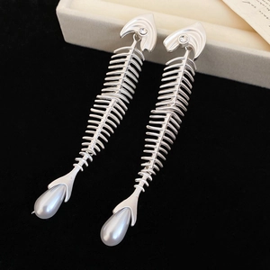 Macro detail of fishbone earrings with cubic zirconia and water drop pearl charms