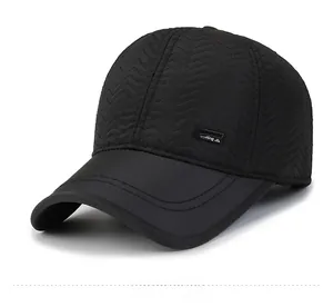 Detail view of black quilted baseball cap with wave pattern stitching and sporting label