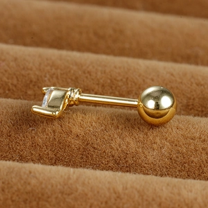 Macro view of gold stainless steel screw ball stud earring with clear zircon drop