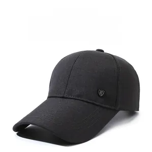 Detail of gray baseball cap featuring a premium metal shield logo and reinforced visor