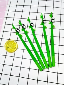 Macro detail of green bamboo-shaped gel pens with cute 3D panda figures on top