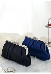 Close-up of pleated satin evening clutch bags with sparkling diamond square buckles
