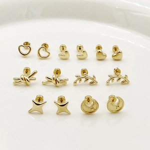 Macro detail of 14K gold plated mini stud earrings set with heart and star shapes
