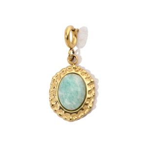 Detailed view of an oval light blue gemstone pendant with a gold wavy textured border