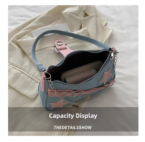 Internal capacity of denim shoulder bag showing phone and wallet storage space