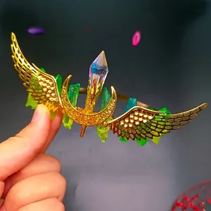 Detail of bohemian gold crown with colorful crystals, golden wings and moon elements