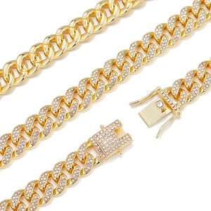 Detailed close-up of a 12mm golden Cuban link chain with luxury iced-out diamond pavé